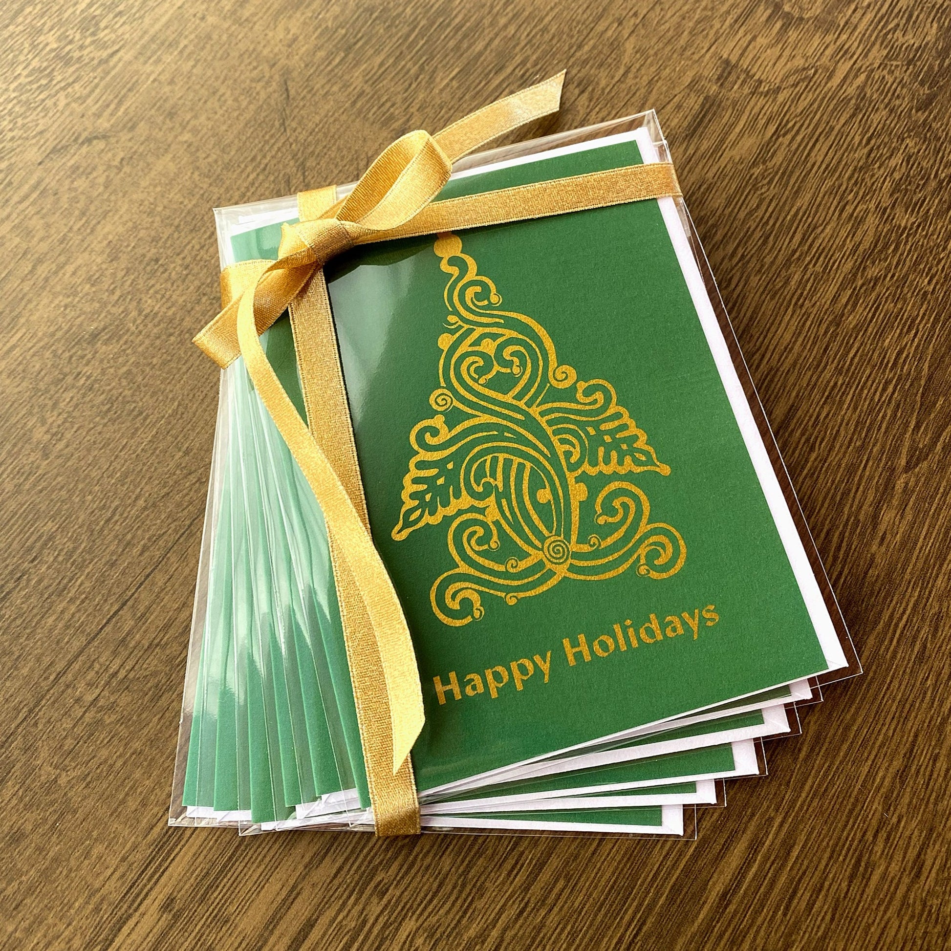 Set of 6 Green Christmas folk tree holiday cards that read "Happy Holidays" and are designed by artist Ariadne Kritonos.