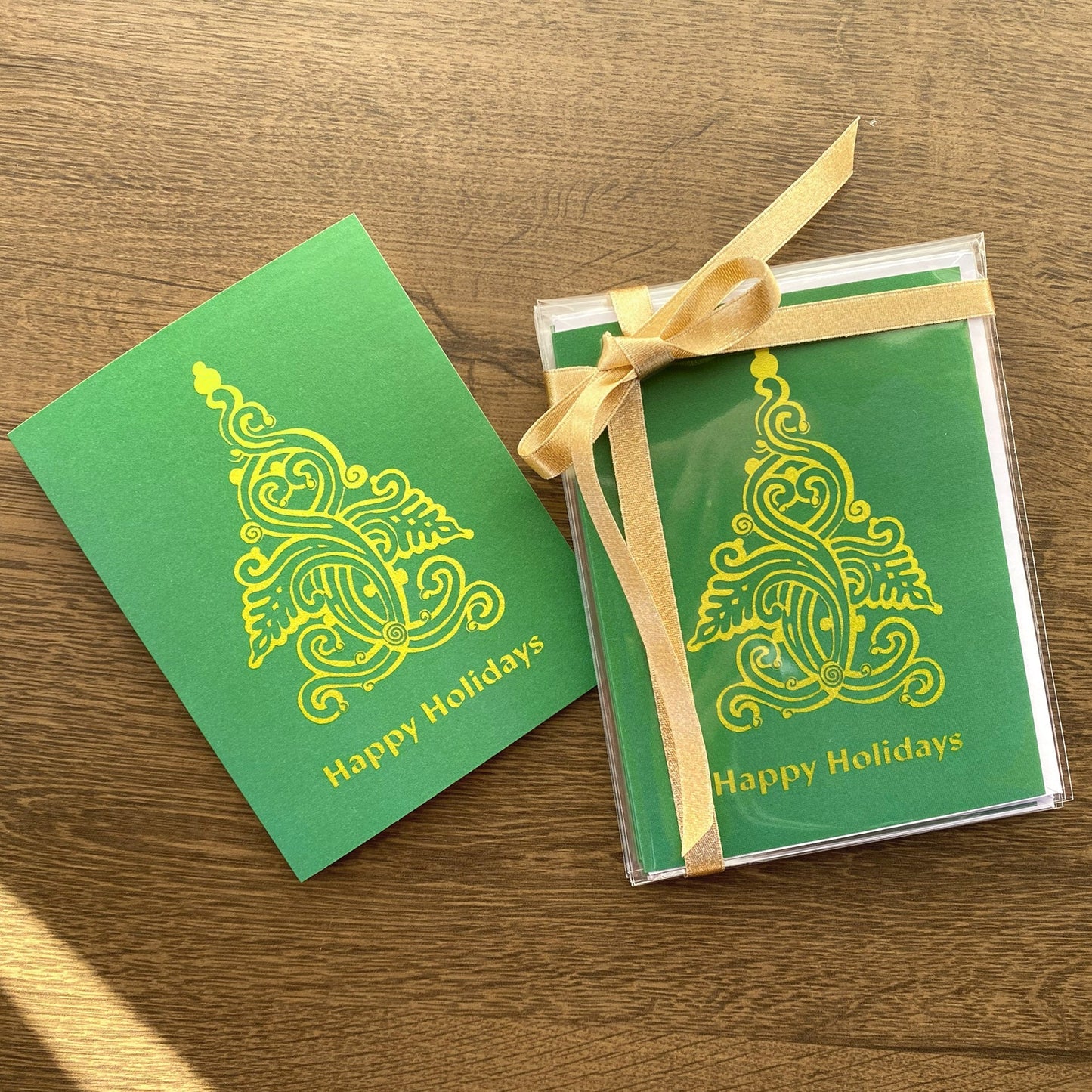 Set of 6 Green Christmas folk tree holiday cards that read "Happy Holidays" and are designed by artist Ariadne Kritonos.